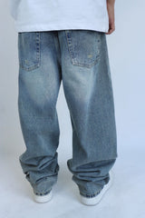 Jeans baggy denim con rotture uomo